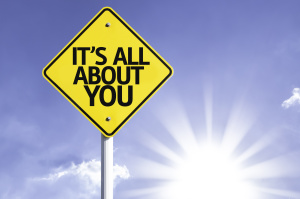 It's All About You road sign with sun background