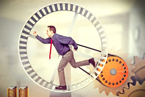businessman run in huge hamster wheel